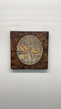 a wooden plaque with an image of a bird on it