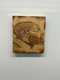 a wood carving of a man with a beard